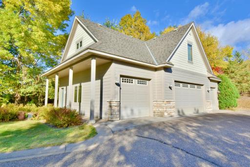 Side entrance view. Four car detached garage, heated & insulated, floor drains, finished man cave spaces upstairs, wired for welding, open extra wide driveway, outside hook up for pressure sprayer.