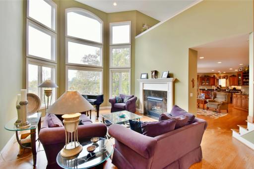 Open & vaulted living room spaces with floor to ceiling windows, double sided gas fireplace, recessed lighting, beautiful hardwood flooring throughout main level. Open concept floor plan
