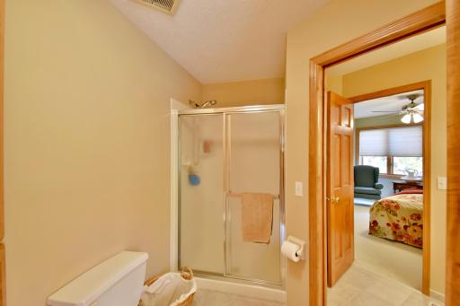 Upstairs 3/4 bath with large linen closet, custom tile & solid surface counter