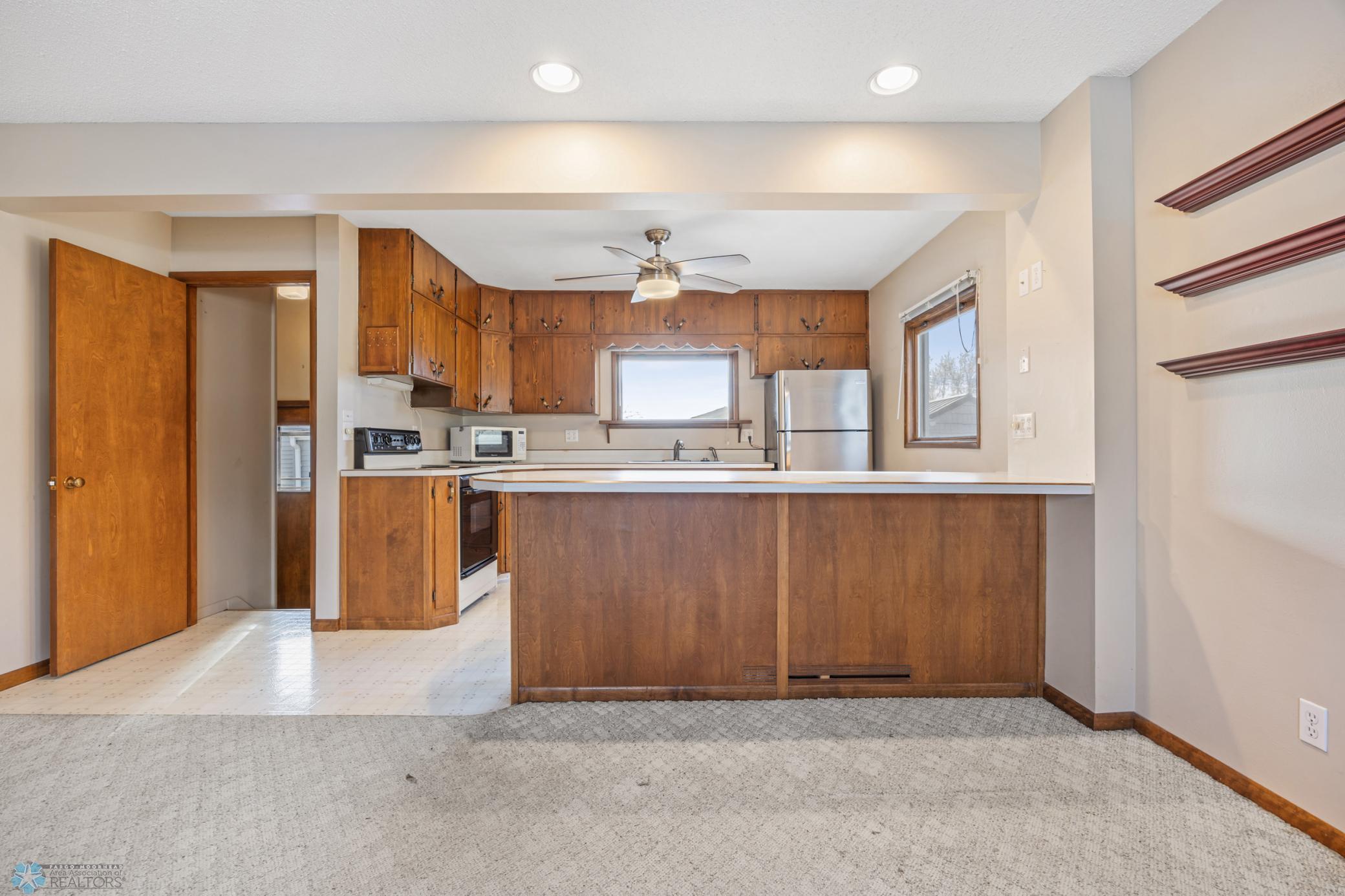 Kitchen- peninsula has over hang on both sides for seating