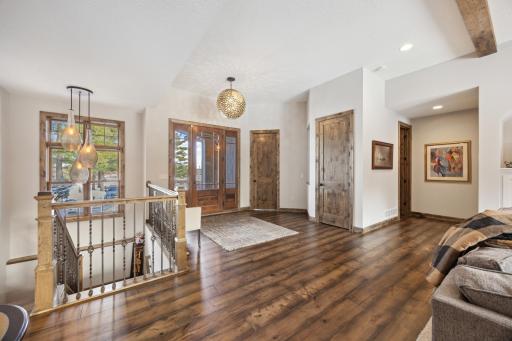 Open foyer with spacious hallways. Note the lighting above stairs and entry light.
