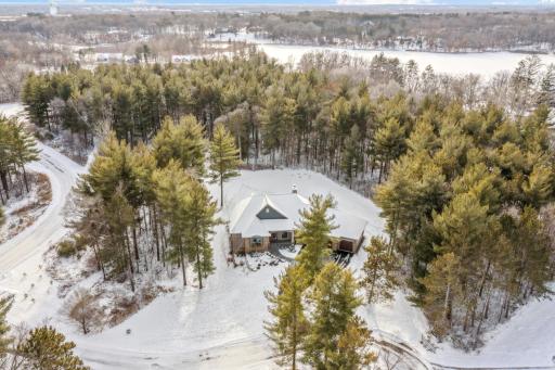 Ultimate acreage lot enveloped by white pines with a huge flat yard space