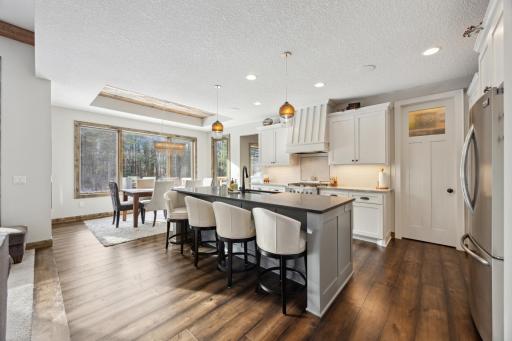Kitchen has large central island with buffed granite top and plenty of seating.