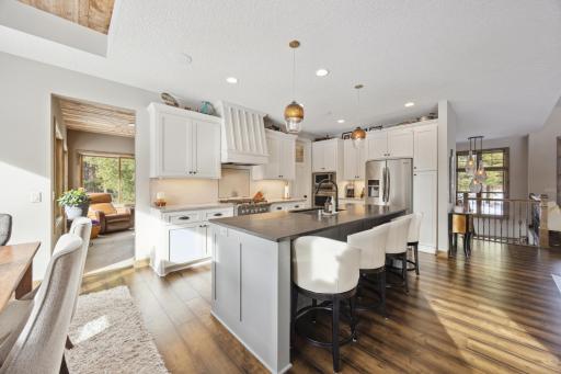 Kitchen has walk-in pantry and pendant lighting.