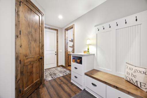 Back hall entry off garage has convenient bench and built-ins. Nice walk-in closet as well.