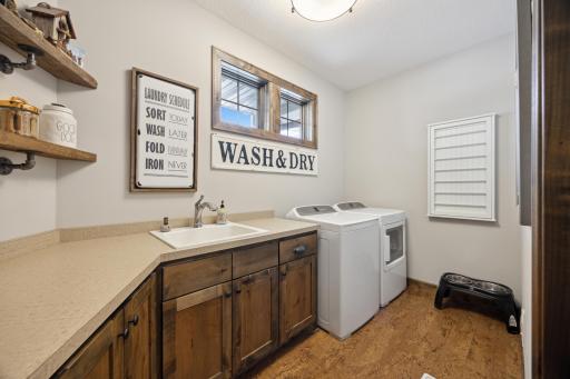 Separate laundry with large folding area and custom built-ins.