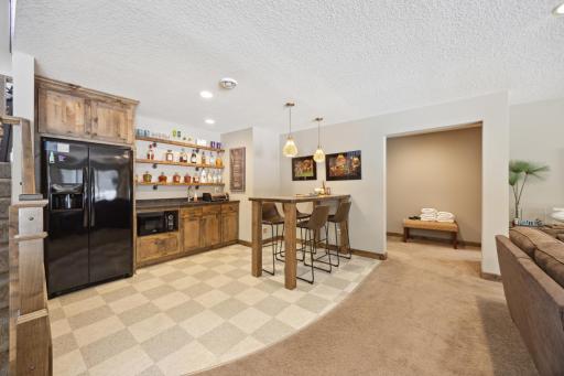 Wet bar has microwave and full fridge, it could be a space to enjoy some snacks or play some card games.