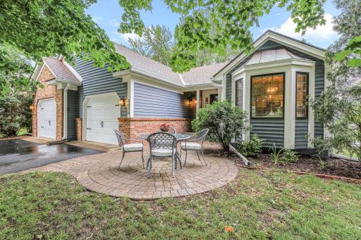 This beautiful custom-built home is nestled under the shade of a stunning maple tree