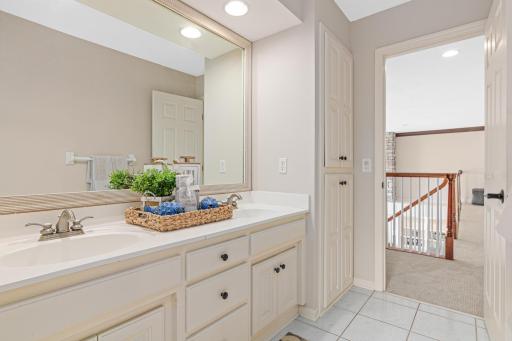Oversized full bathroom with double sinks and a separate tub/commode area—ideal for multiple people getting ready at once, offering both convenience and privacy.