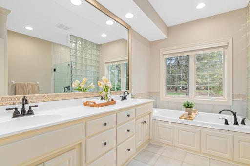 Enjoy tranquil views of the private/treed yard through the window over the soaking tub—your own private oasis for relaxation and reflection.