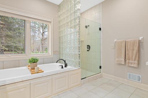 Indulge in relaxation in this oversized primary bathroom, featuring a separate bath and shower, along with double sinks for effortless preparation—perfect for your morning routine.