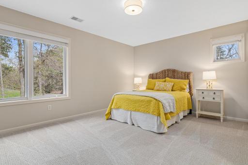 The third of three spacious bedrooms on the upper floor, featuring a large walk-in closet, new carpet, fresh paint, and an updated light fixture—perfect for comfort and style.