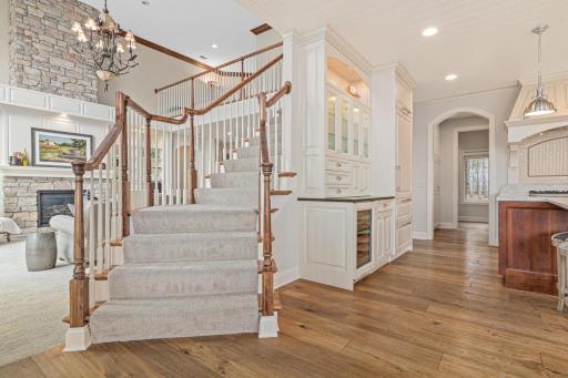 Grand staircase leads upstairs to three spacious bedrooms, a bathroom, and a loft- new carpet and fresh paint. A large catwalk offers stunning views of the lake, enhancing the home's open, airy feel.