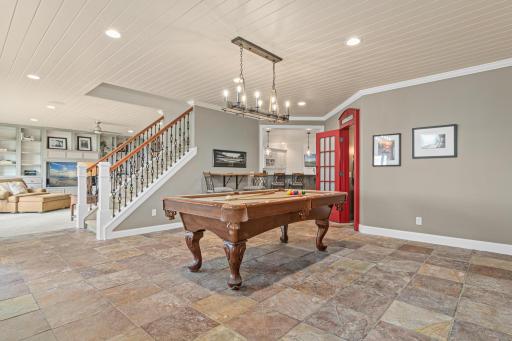 Another angle of the billiards area, with a seamless view into the family room and bar area—each space perfectly positioned to take in stunning lake views.