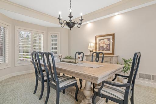 Spacious dining room, conveniently located near the kitchen, is perfect for more formal entertaining. Host your next holiday gathering in this elegant space overlooking the beautiful yard.