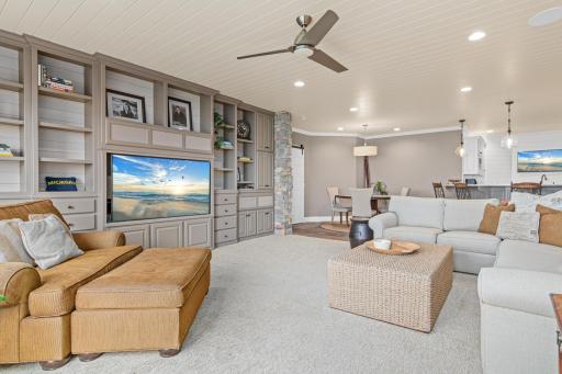 From the family room, enjoy the open layout leading to the card playing area and large horseshoe bar—perfect for entertaining and casual gatherings.