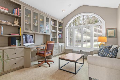 Main floor executive office with custom built-ins, a serene view of the yard, and French doors—perfect for quiet conversations or focused work.