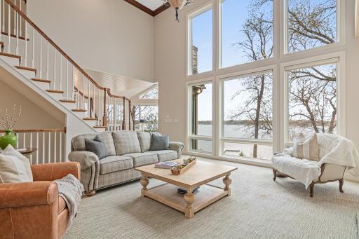 Stunning living room with a wall of windows showcasing breathtaking Turtle Lake views. Postcard worthy sunsets every night.
