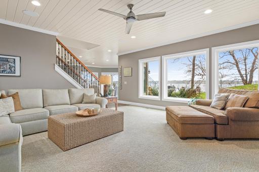 Lower-level family room with stunning lake views—ideal for watching the big game or your favorite movie, creating a cozy yet expansive space for relaxation.