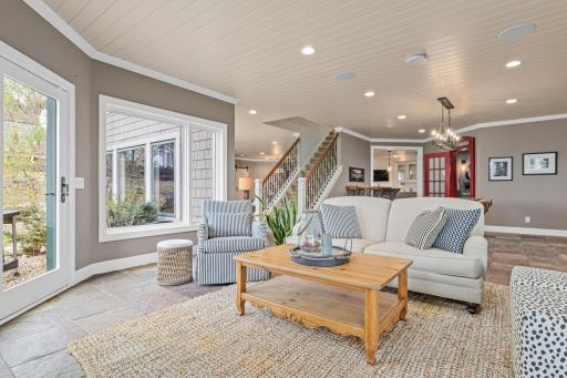 View from the lower-level hearth area looking toward the pool table, half bathroom, and bar—creating a perfect flow for both relaxation and entertainment. Heated floors provide for warm toes all winter!