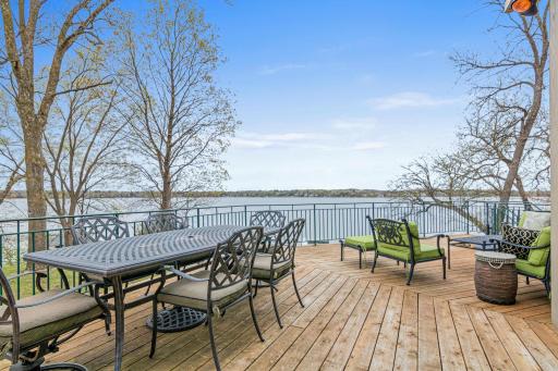 Spacious, oversized deck with multiple areas designed for relaxation—whether you're dining, enjoying casual conversation, or soaking up the sun, this outdoor space is perfect for every occasion.