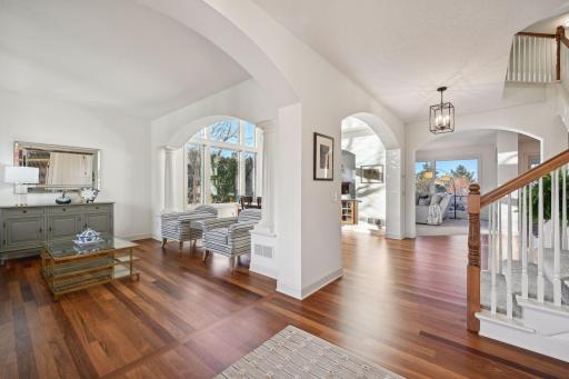 Entryway with living room to the left flowing into the dining room.