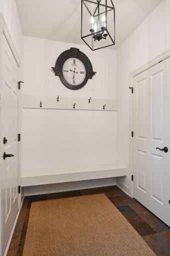 Main floor mud room with built in bench and large closet.