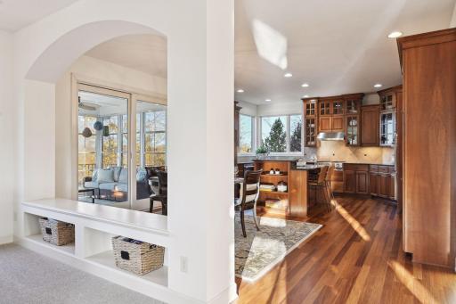 Bench separating the family room from the kitchen has a convenient space to house games or blankets