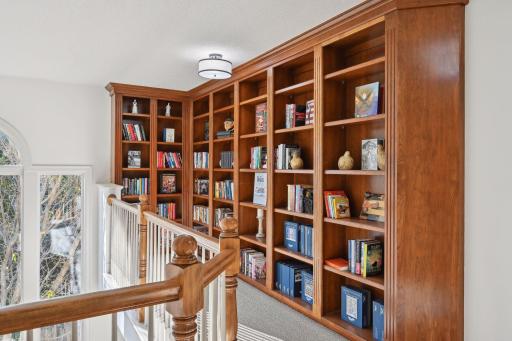 Built in bookshelves in upper level loft overlooks the dining room.