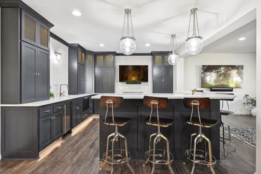 Lower level bar is gorgeous and functional with a convection oven/microwave, dish washer, ice maker, beverage fridges, dual temp wine fridge and plenty of countertop space to have an amazing spread for your next gathering!