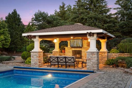 Pool pavilion is wired for a tv and features a wood burning fireplace. Soak in the pool while watching the game!