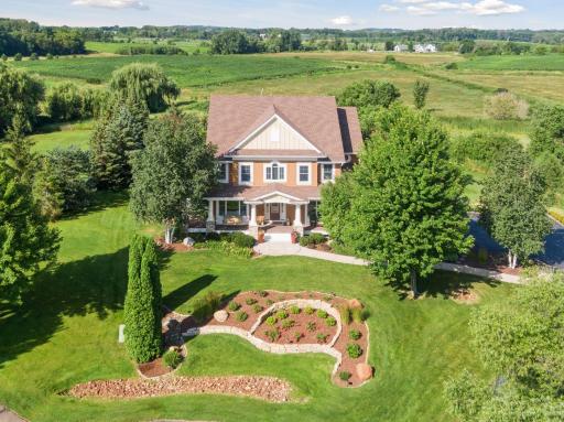 Entire yard is professionally landscaped with mature trees.