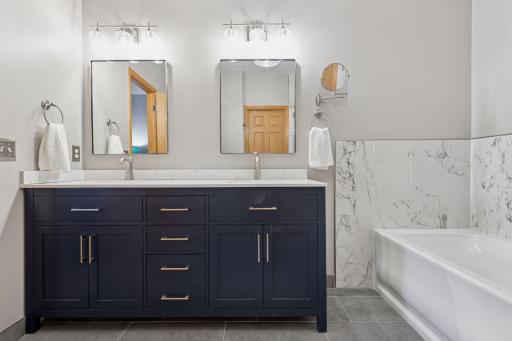 Two sinks with updated vanity, mirrors, lighting and more