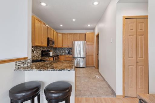 Granite counters and lots of cupboard space, plus large pantry cupboard next to refrigerator