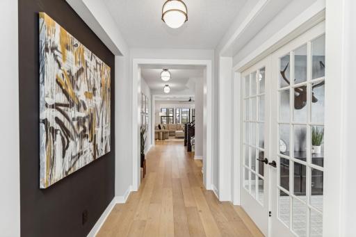 The hallway leads you to the heart of this home, with its high ceilings and French office doors, serves as an architectural highlight that enhances the overall aesthetic of the home.â