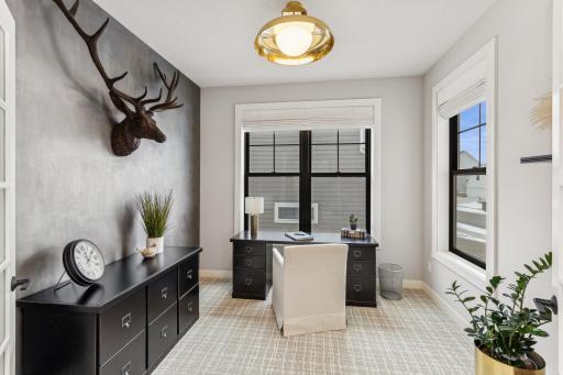 The large windows contribute to a stylish and modern aesthetic, making the home office a visually appealing and comfortable place to work.