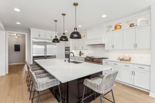Experience functional luxury in this kitchen, featuring state-of-the-art appliances, a large island that serves as the centerpiece, and extensive storage options to accommodate all your culinary needs.
