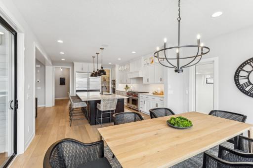 From the dining room, the seamless flow into the kitchen creates a cohesive space that can be dressed up for formal occasions or kept relaxed for everyday meals