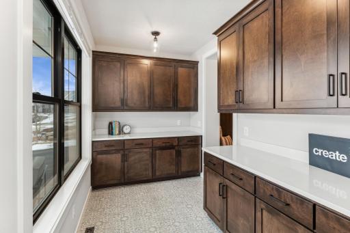 Situated at the front of the house near the foyer, this space features a thoughtfully designed layout with ample built-in cabinetry, providing both functionality and style. Its seamless connection to the rest of the home enhances its practicality.