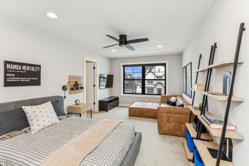 One of the 4 bedrooms on upper level, adorned with a nice-sized window that floods the space with natural light. Adjacent to it, a walk-in closet awaits, providing ample storage for your wardrobe and accessories.