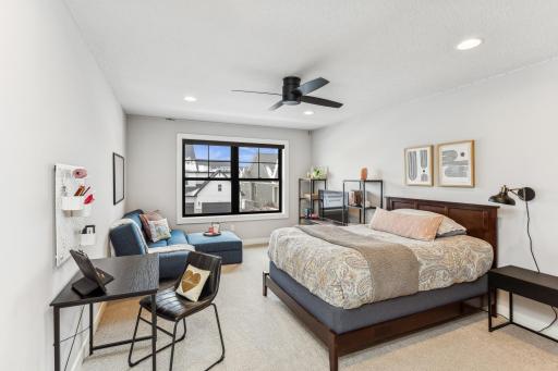 A nicely sized upper-level bedroom with a walk-in closet and convenient access to a nearby bathroom offers both comfort and practicality.