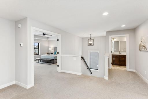 The expansive upper-level hallway serves as a central hub, gracefully connecting the bedrooms and laundry room, ensuring easy access and a seamless flow throughout the space