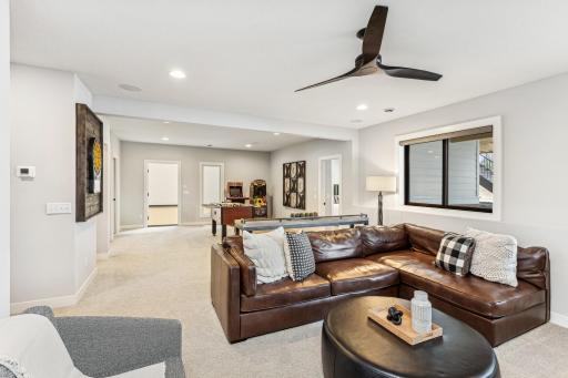 The large windows frame the vibrant activity within, allowing natural light to flood the space and creating a seamless connection between indoor comfort and the dynamic energy of the sport court.