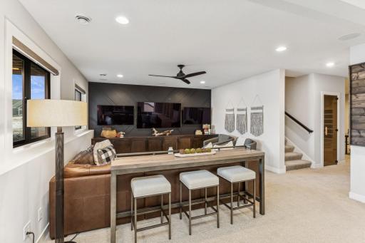 The lower level is an entertainment paradise, featuring three TVs a versatile space is perfect for movie nights, sports viewing, and immersive gaming sessions, making it a favorite gathering spot.