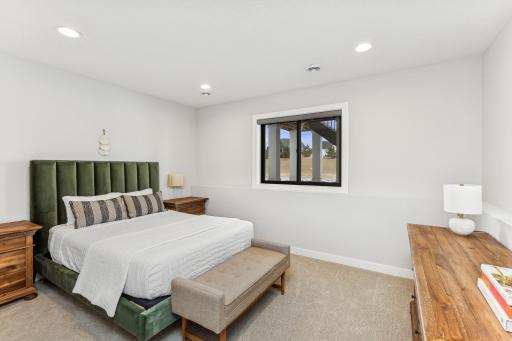 The fifth bedroom, located on the lower level, offers a private and cozy retreat. This versatile space can be used as a guest room, home office, or personal sanctuary, providing flexibility to suit your needs.