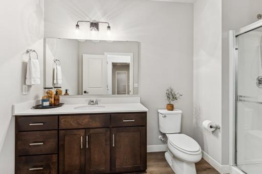 The lower level 3/4 bath is conveniently located near the indoor sport court, providing easy access for players and guests. This proximity ensures that everyone can quickly freshen up after a game or workout.