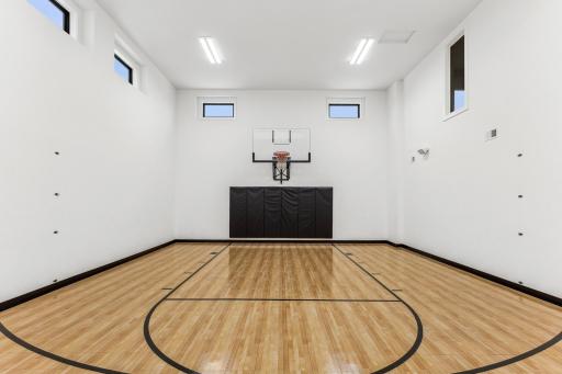 The sport court is equipped with a versatile volleyball setup, perfect for both casual games and competitive matches. The well-maintained court provides an ideal space ensuring hours of fun year round