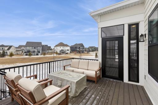 The rear deck features a maintenance-free design with durable decking and railing, ensuring long-lasting beauty and ease of care. This inviting space seamlessly leads to the backyard, providing a perfect spot for outdoor relaxation and entertainment.