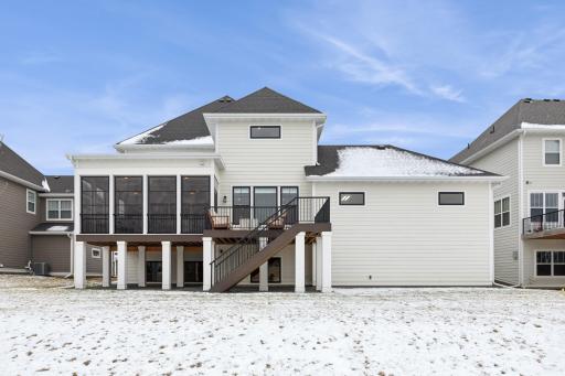 The back of the home showcases a beautiful deck and a closed porch, offering versatile outdoor living spaces. The deck provides an open area for relaxation and entertainment, while the closed porch offers a shelter even in inclement weather.