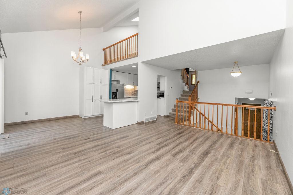 Living Room view to Foyer, Upper level & Kitchen